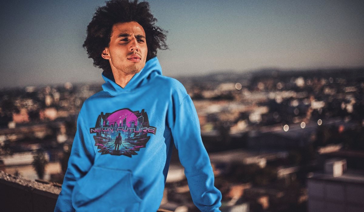 Man on a rooftop at sunset wearing blue Neon Future cyberpunk hoodie