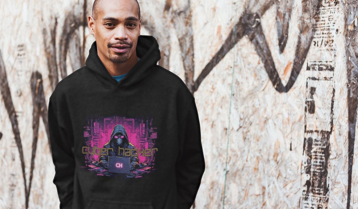 Man wearing black Cyber Hacker hoodie against a graffiti wall